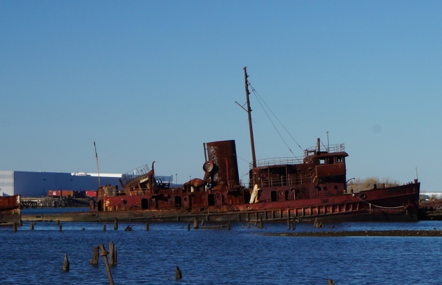 Rusted steam powered tugboat beached in Arthur Kill