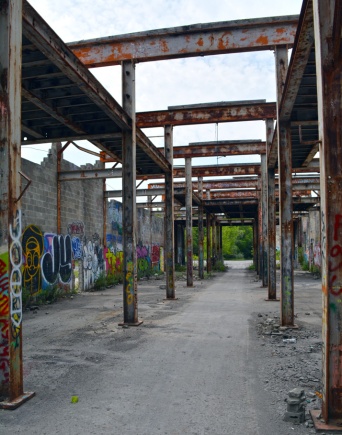 Roofless cinder block building with graffiti on walls