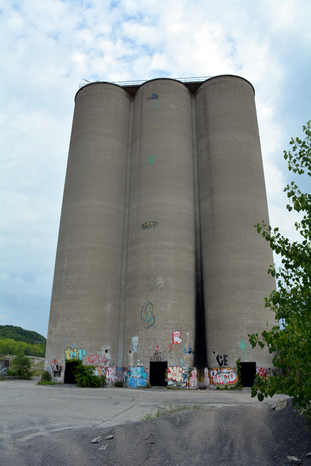 Concrete silos behind concrete and gravel drive